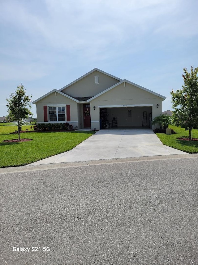 ranch-style house featuring a garage and a front yard