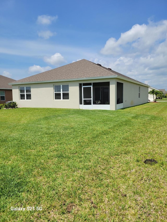 rear view of property with a yard