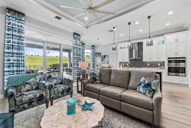 living room with crown molding, light hardwood / wood-style flooring, and ceiling fan