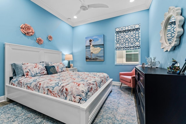 bedroom with ceiling fan, hardwood / wood-style flooring, and ornamental molding