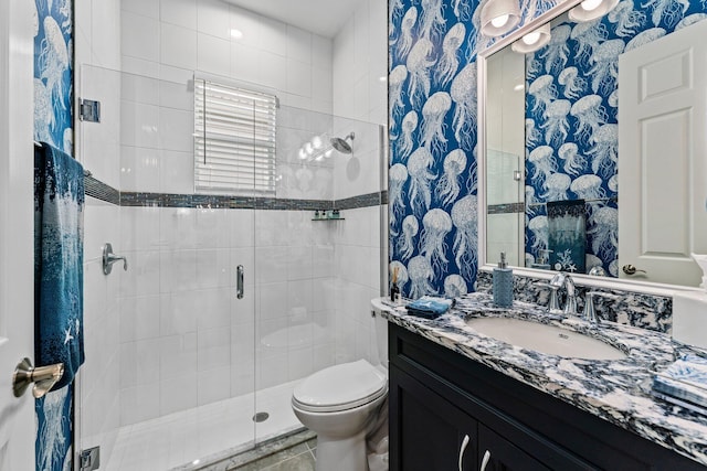 bathroom with vanity, toilet, and a shower with shower door