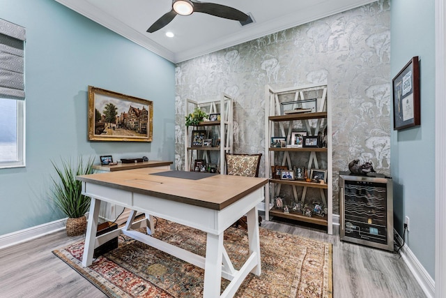 office with hardwood / wood-style flooring, ceiling fan, ornamental molding, and beverage cooler