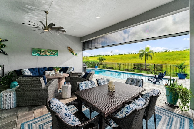 view of patio featuring a rural view, an outdoor living space, a fenced in pool, and ceiling fan