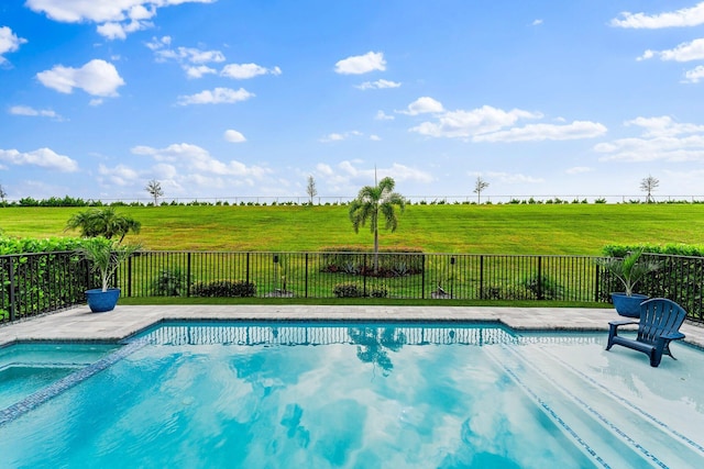 view of swimming pool with a rural view