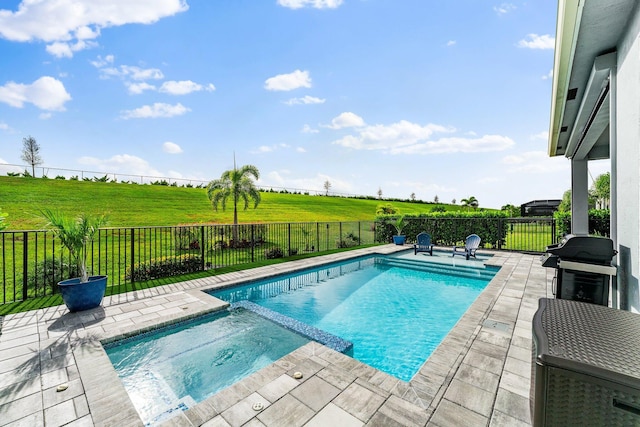 view of swimming pool featuring an in ground hot tub, a grill, a rural view, a patio area, and a lawn