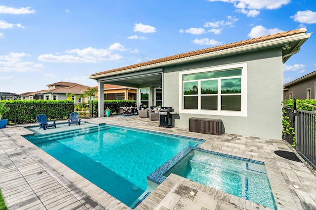 view of pool featuring an in ground hot tub and a patio