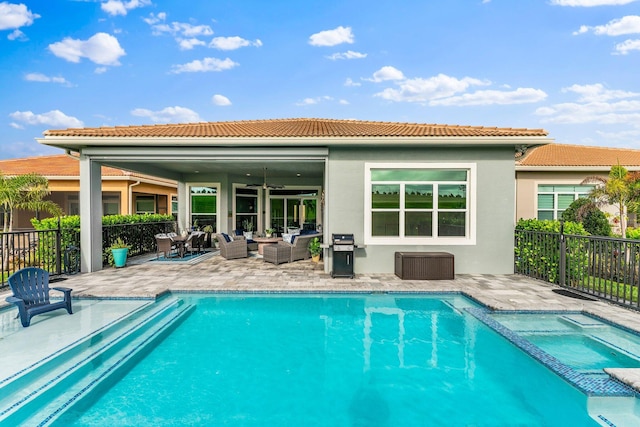 back of property with a fenced in pool, a patio area, an outdoor living space, and ceiling fan