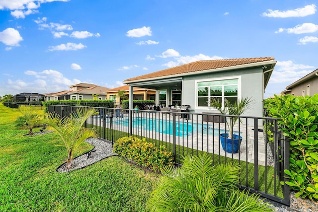 view of swimming pool featuring a patio and a lawn