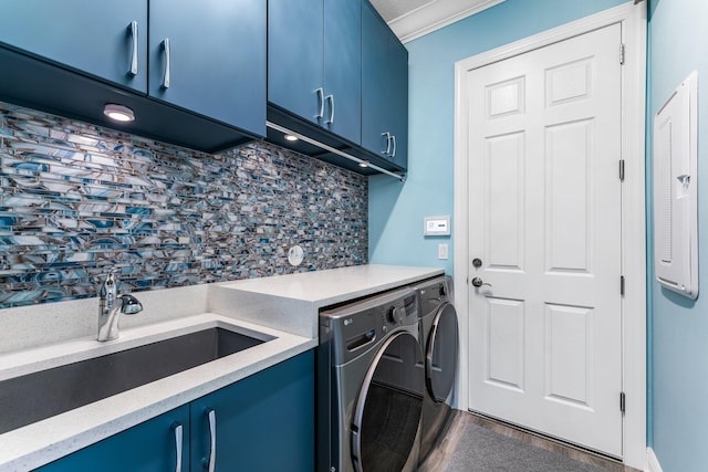 laundry area featuring cabinets, crown molding, sink, separate washer and dryer, and hardwood / wood-style floors