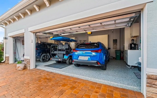 garage with electric panel and a garage door opener