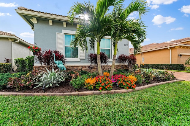 mediterranean / spanish house featuring a front yard