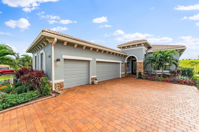 mediterranean / spanish house with a garage