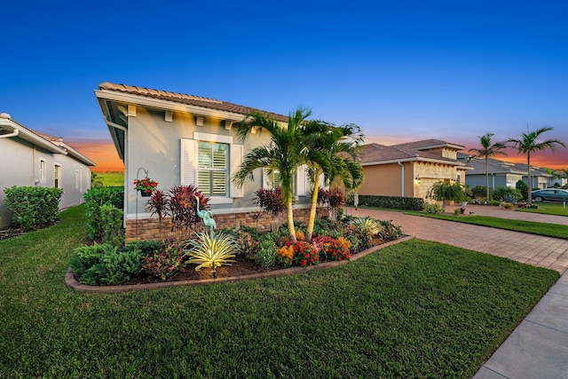 mediterranean / spanish home with a lawn