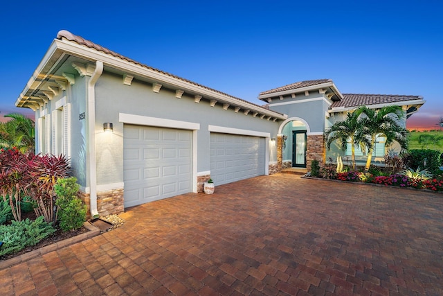 mediterranean / spanish home featuring a garage