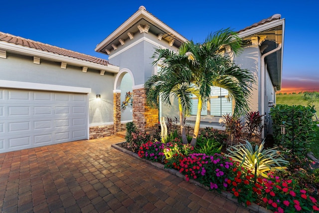 mediterranean / spanish-style house with a garage