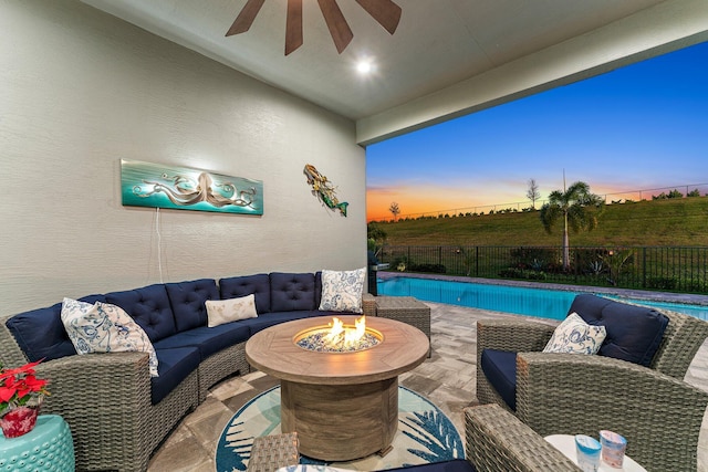 pool at dusk featuring a fire pit