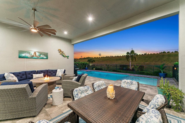 pool at dusk with a grill, an outdoor fire pit, and a patio