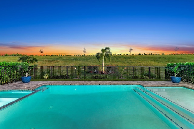 view of pool at dusk