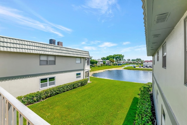 view of yard with a water view and central air condition unit