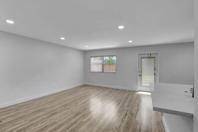 spare room featuring light hardwood / wood-style floors