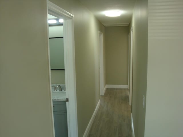 corridor featuring light hardwood / wood-style floors and sink