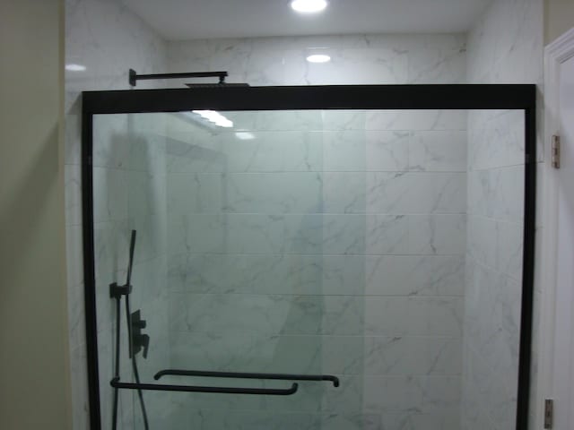 bathroom with a shower with shower door