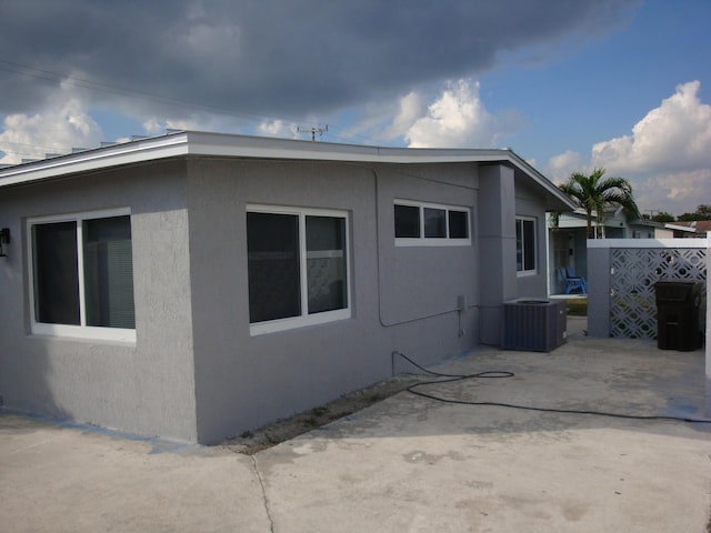 view of property exterior featuring a patio area and cooling unit