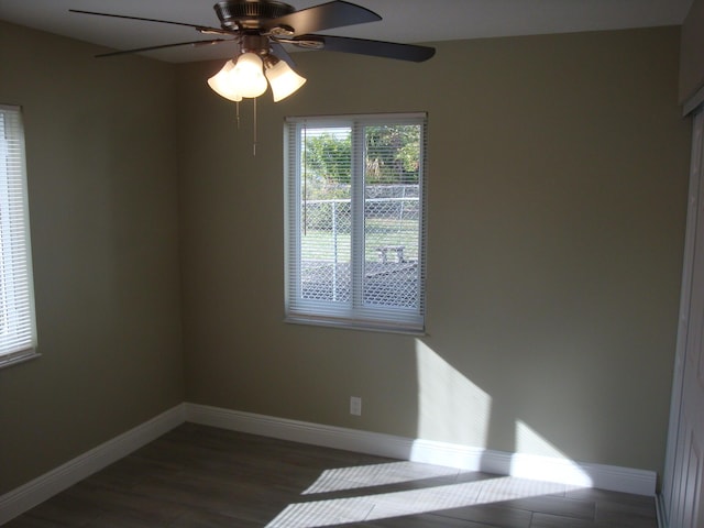 empty room featuring ceiling fan and dark hardwood / wood-style floors