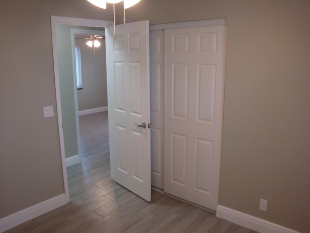 unfurnished bedroom featuring a closet and light hardwood / wood-style flooring