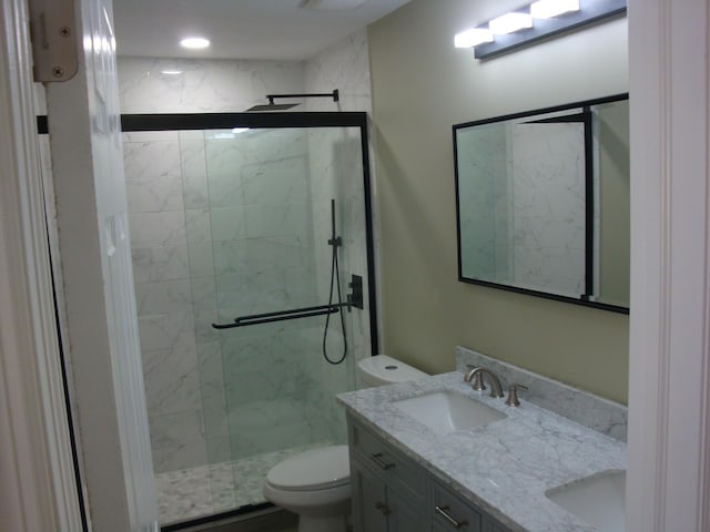 bathroom featuring vanity, toilet, and walk in shower