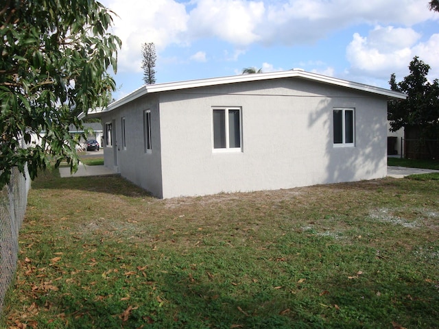 view of property exterior with a yard