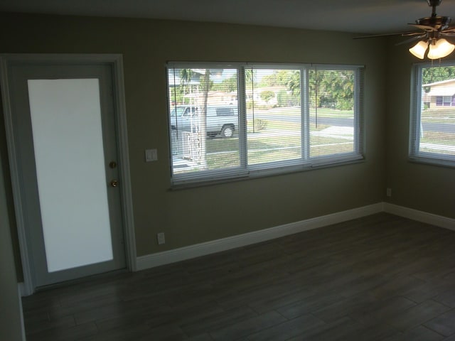 unfurnished room featuring ceiling fan and dark hardwood / wood-style flooring