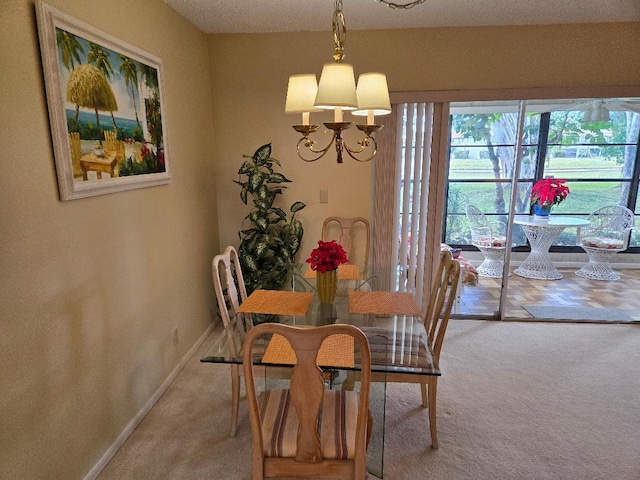 dining area featuring carpet and a notable chandelier