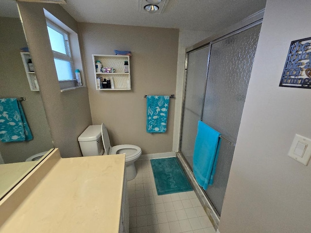 bathroom featuring vanity, toilet, and an enclosed shower