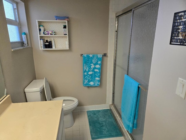 bathroom with a shower with door, vanity, and toilet