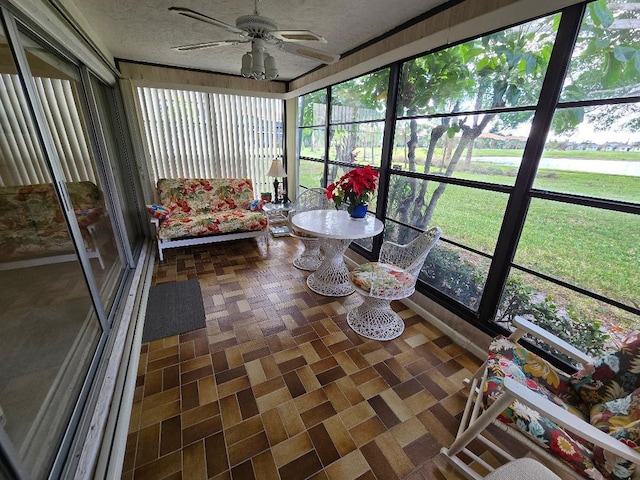 sunroom featuring ceiling fan