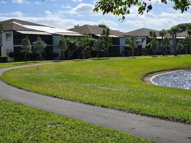 view of home's community with a yard