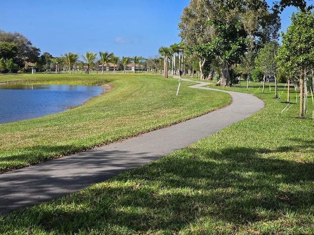 view of community with a lawn and a water view