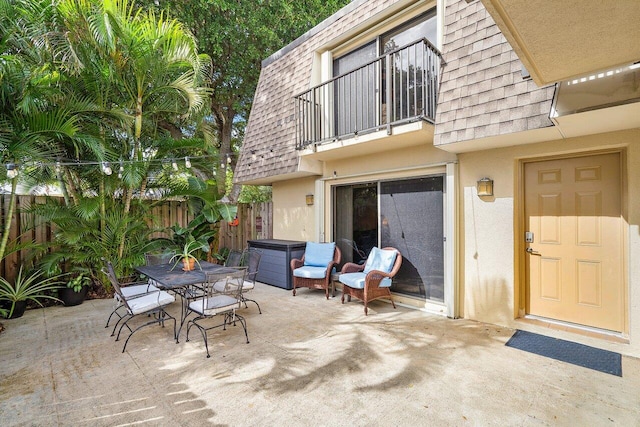 view of patio / terrace featuring a balcony and a hot tub