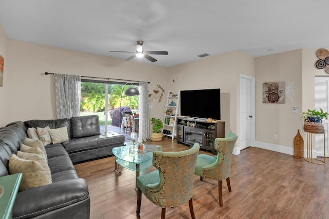 living room featuring hardwood / wood-style floors and ceiling fan