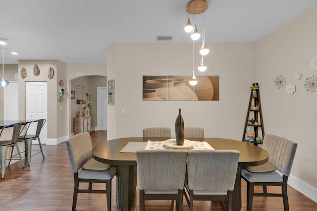 1273 SW 48th Ter, Deerfield Beach, FL 33442 - dining area featuring arched walkways and dark wood-style floors