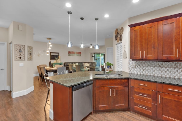 1273 SW 48th Ter, Deerfield Beach, FL 33442 - kitchen with dishwasher, a peninsula, wood finished floors, a kitchen bar, and recessed lighting