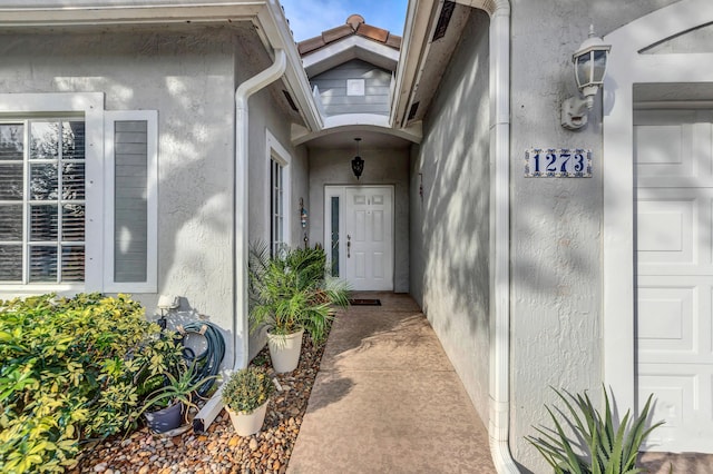 1273 SW 48th Ter, Deerfield Beach, FL 33442 - view of exterior entry featuring stucco siding