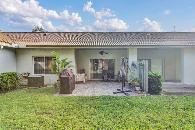 rear view of house with ceiling fan, a yard, a patio, and central air condition unit