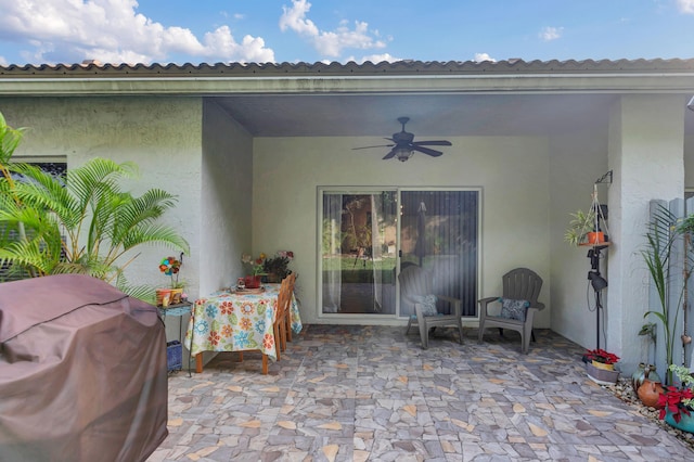 view of patio / terrace with ceiling fan and a grill