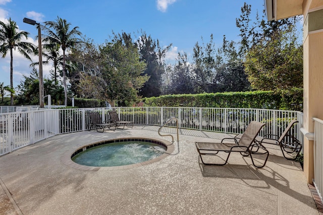 view of pool featuring a patio area and an in ground hot tub