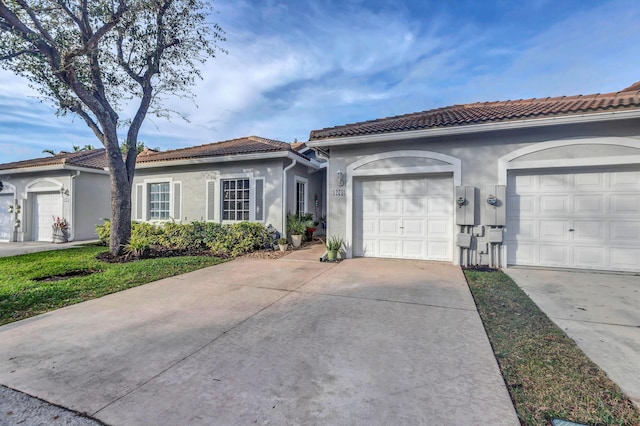 1273 SW 48th Ter, Deerfield Beach, FL 33442 - view of front facade with stucco siding, driveway, a garage, and a tile roof