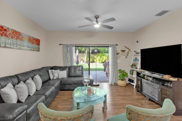 living room featuring ceiling fan and wood-type flooring