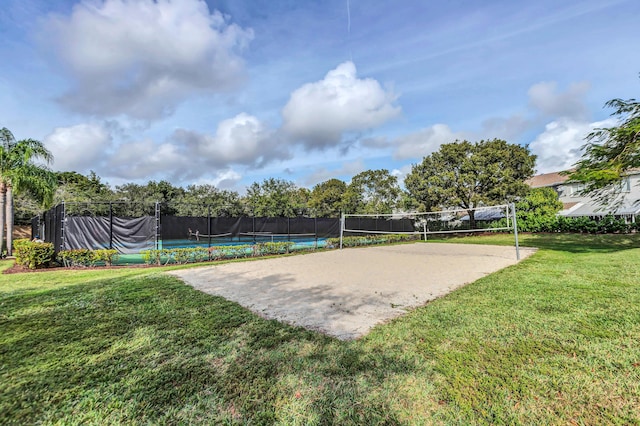 view of community featuring volleyball court and a lawn