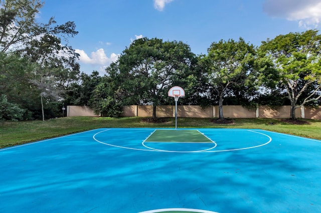 view of basketball court featuring a yard